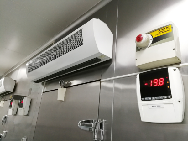 Close-up of a thermostat showing the temperature of a cold room used for pharmaceutical storage